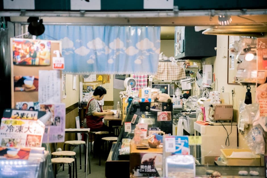 An owner behind the counter of a small, independent shop